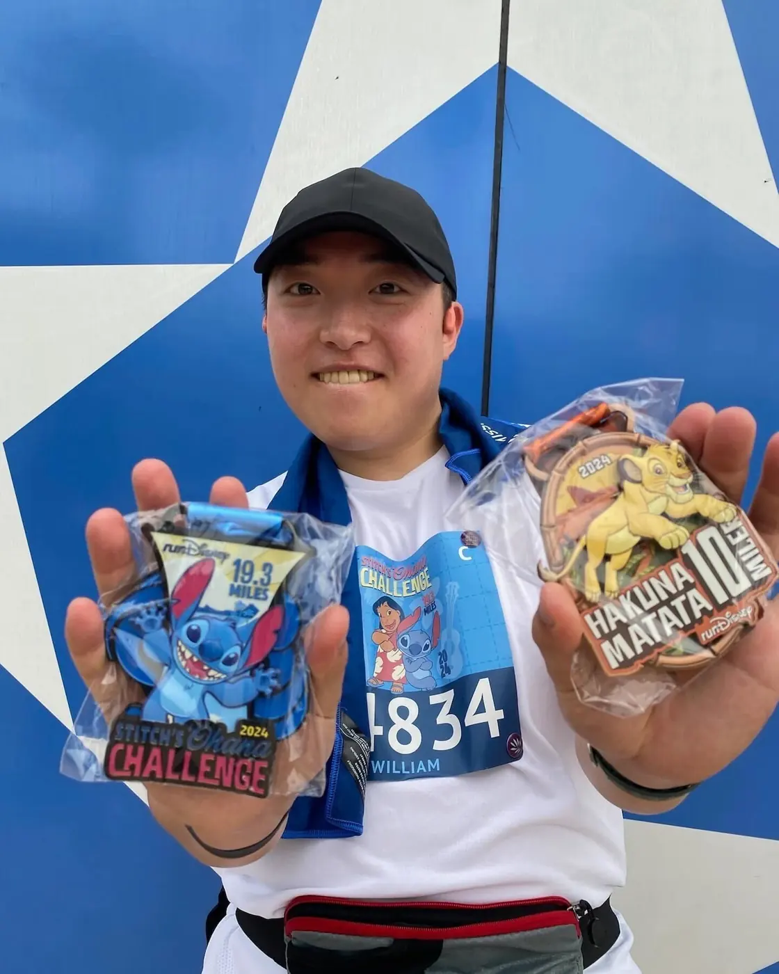 Will grinning and holding up two race medals