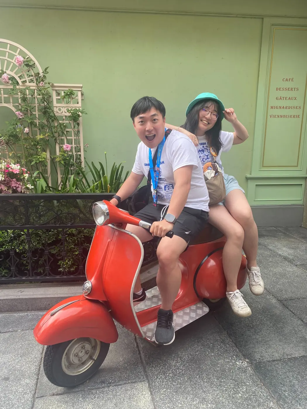 Will and a friend posing on a red scooter